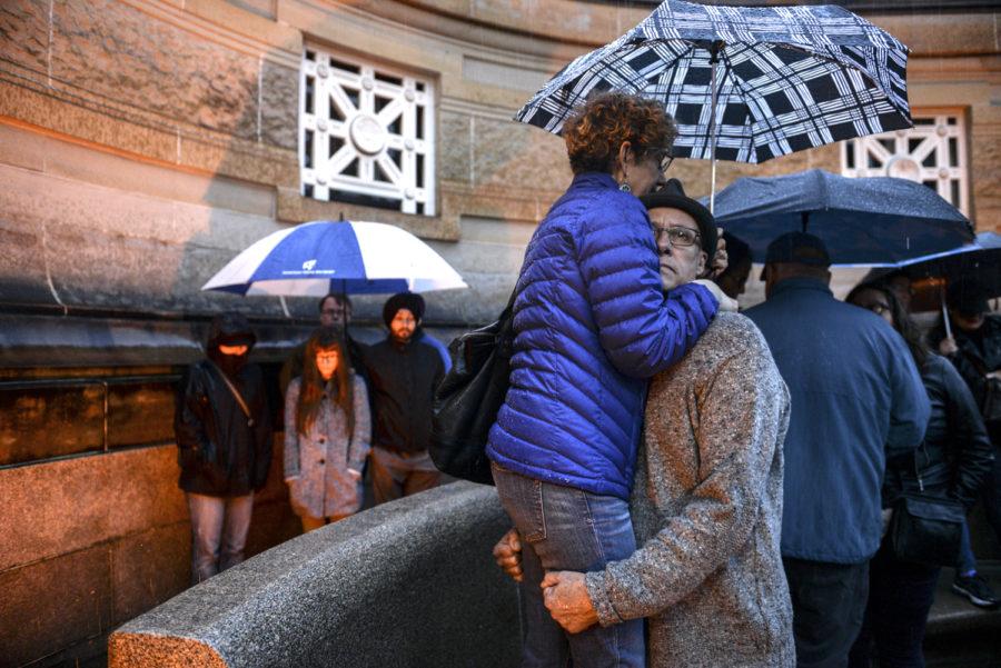 Two people embrace in the crowd that overflowed outside Soldiers and Sailors Memorial Hall Sunday evening during a vigil that mourned the victims of the Tree of Life Synagogue massacre. 