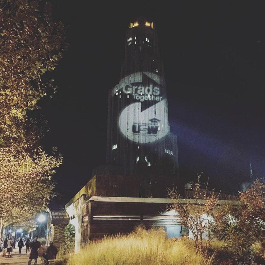 Pitt grad student union organizers, in conjunction with United Steelworkers, projected their campaign logo on the Cathedral last year.