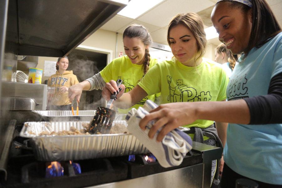 Rachel Feil, Ashley Ward-Willis and Sydney Massenberg (left to right) cook chili for the 46 people who attend the Circles program at the YWCA in Homewood. (Photo by Theo Schwarz | Senior Staff Photographer)
