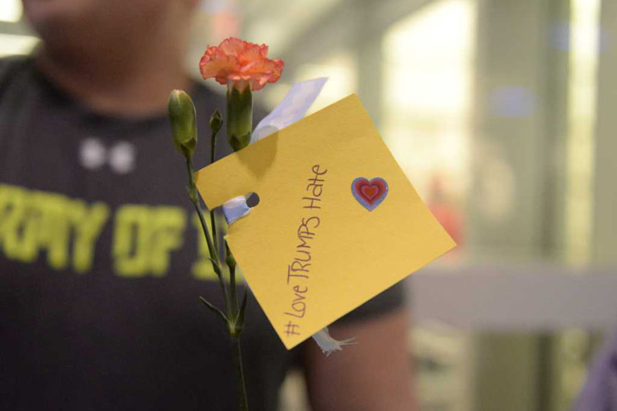 Peaceful protesters handed flowers that read “#LoveTRUMPSHate” to Trump supporters at a protest outside the David Lawrence Convention Center on April 16, 2016, where Trump was expected to speak.