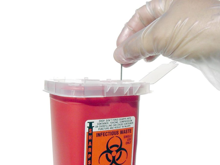 A single-use sharps disposal container.