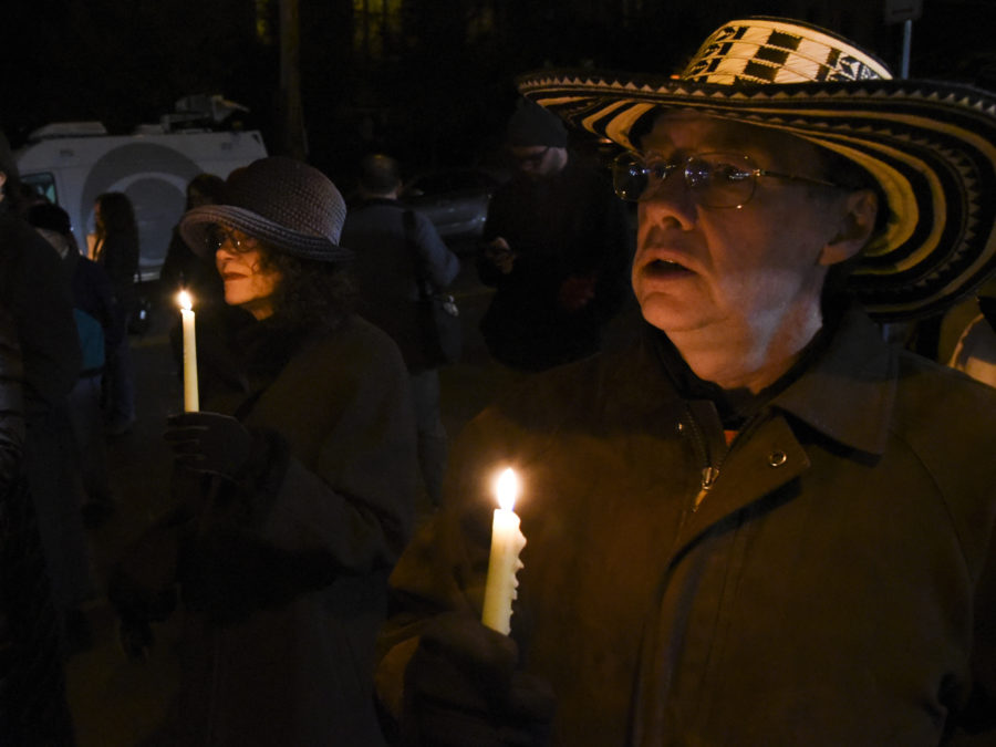 Roger Day and Abby Resnick of Squirrel Hill join in singing a Hebrew song at the vigil mourning the lives lost in the Squirrel Hill synagogue shooting Saturday morning. Day and Resnick are Jewish but they are not currently affiliated with a synagogue.