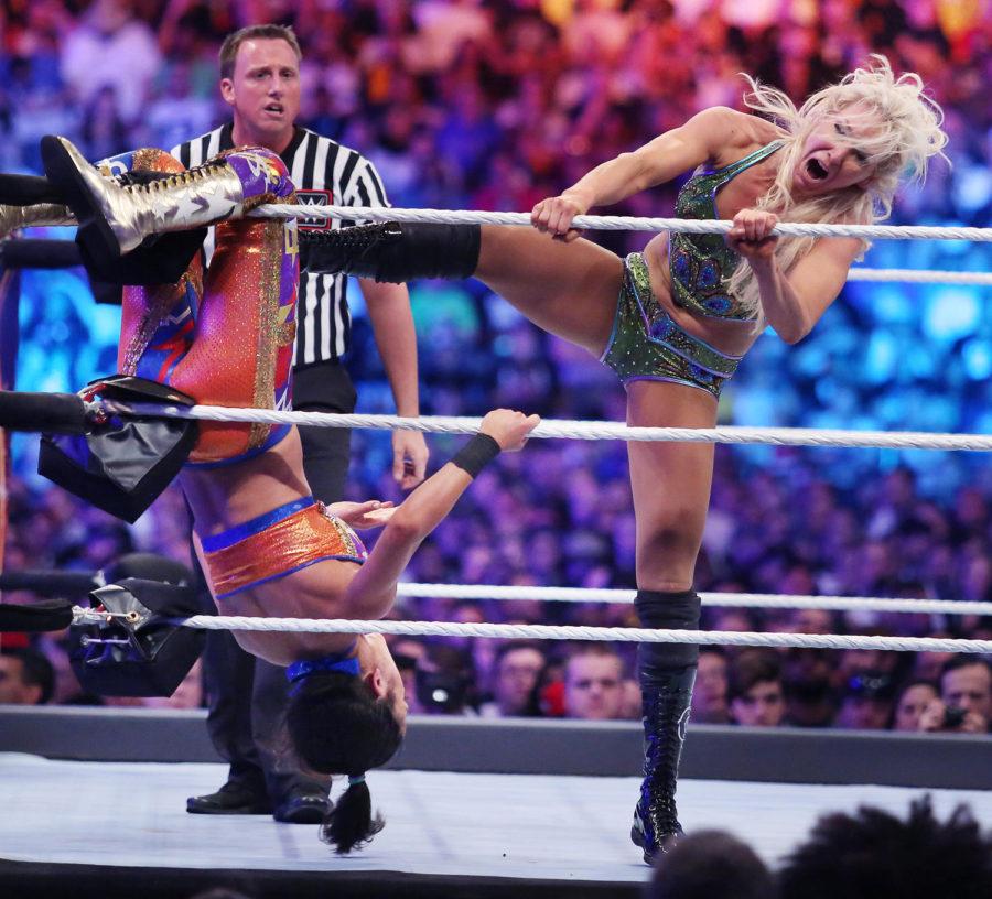 Charlotte Flair (right) kicks Bayley during WrestleMania 33 on April 2, 2017, at Camping World Stadium in Orlando, Florida.
