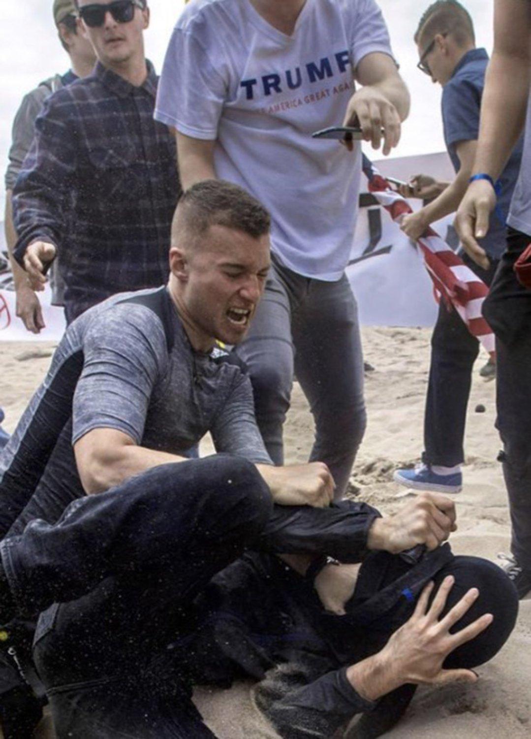 A screenshot from video reportedly shows Robert Rondo, leader of the so-called Rise Above Movement, attacking a counter-protestor at an event in Huntington Beach, Calif., in March 2017. The photo was included in a criminal complaint released by the Department of Justice. (Department of Justice/TNS)