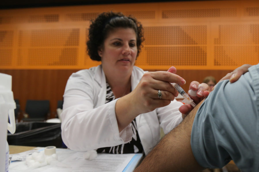 Deanne Hall — an assistant professor in the School of Pharmacy and Therapeutics — works at the Oct. 10 flu shot clinic in Benedum Hall.