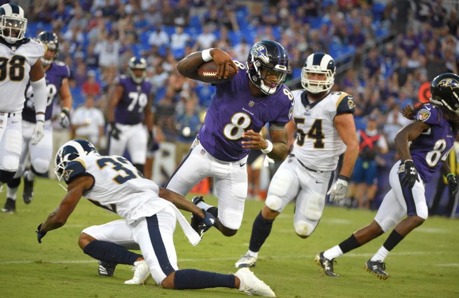 Baltimore Ravens quarterback Lamar Jackson (8) scores a touchdown after making a cut on the Los Angeles Rams’ Troy Hill (32) in the first half during a preseason game at M&T Bank Stadium in Baltimore on Aug. 9.
