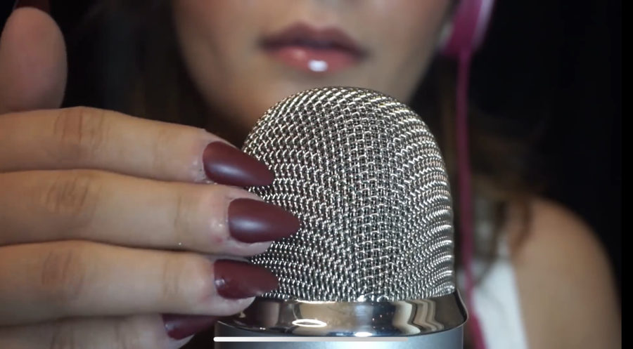 Pittsburgh native Lilliana Dee taps her acrylic nails on a microphone for an ASMR video on her YouTube channel that has more than 200,000 subscribers.