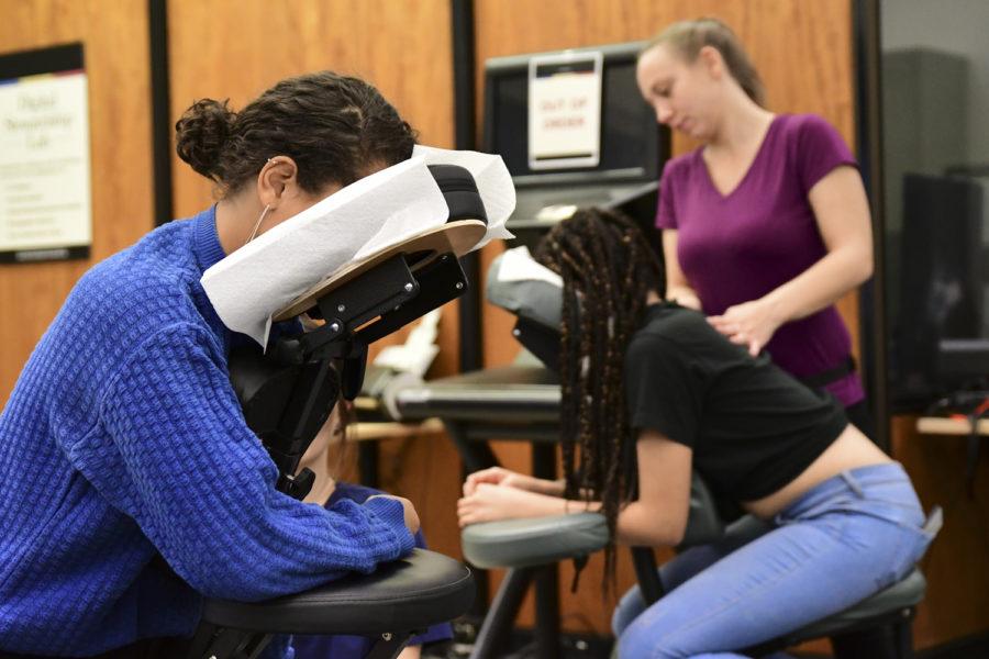 Junior non-fiction writing and communication double major Abigail Tesfay (left) received a massage from a professional masseuse during Hillman’s “Long Night Against Procrastination” event Monday night. 
