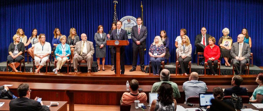 Pennsylvania Attorney General Josh Shapiro, center, speaks on the findings of the grand jury report on child sexual abuse in six Catholic dioceses at the State Capitol, with 16 victims or family members of victims of sexual abuse by Catholic priests seated on stage with him on Aug. 14. 
