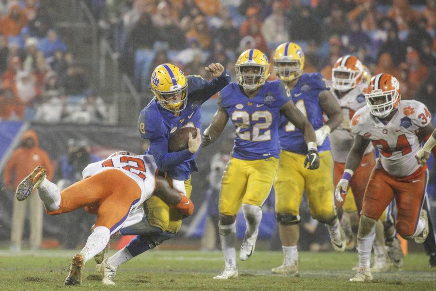 Sophomore quarterback Kenny Pickett gets tackled during the team’s 42-10 loss to Clemson Saturday night. 