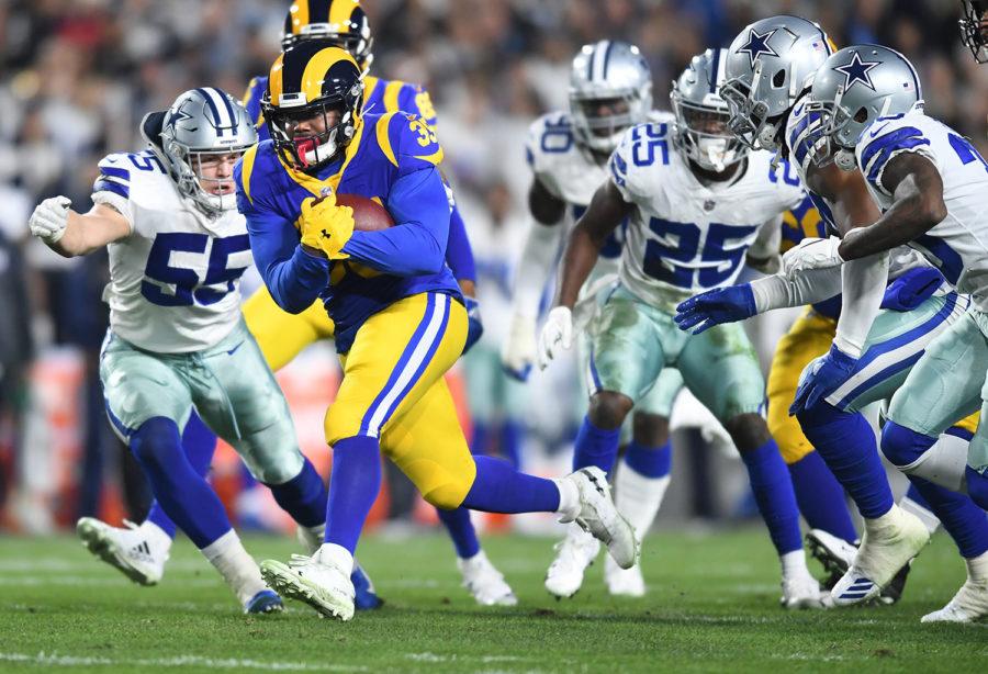 Los Angeles Rams running back C.J. Anderson picks up yards against the Dallas Cowboys in the first quarter during the NFL Divisional Round at the Los Angeles Memorial Coliseum on Saturday. 
