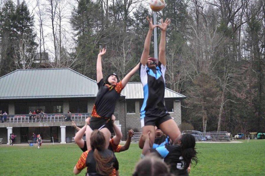 The Woodland Hills Girls Rugby team, pictured here in blue, lost only three of its games in its first season. 