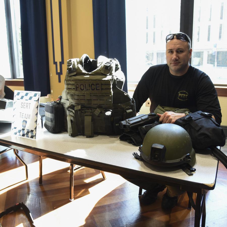 Mike Matta, a detective at the Pitt Police and a member of the Special Emergency Response Team, sits at a table informing visitors about the SERT team. 

