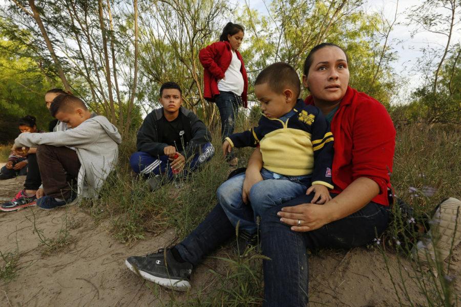 Hayti Alvarado, 26, holds her son Esteban Alvarado, 3, along with her daughter Gabriella Alvarado, 11, (not shown) after being detained near the Rio Grande River. The Alvarado family had to flee their country after Gabriella was threatened at school. A report suggests thousands more children were separated from their families by the Trump administration than previously disclosed. 