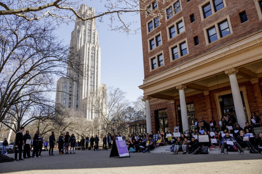Around 120 students gathered outside the William Pitt Union on Wednesday afternoon for a silent and peaceful die-in demonstration, which lasted around 40 minutes. 

