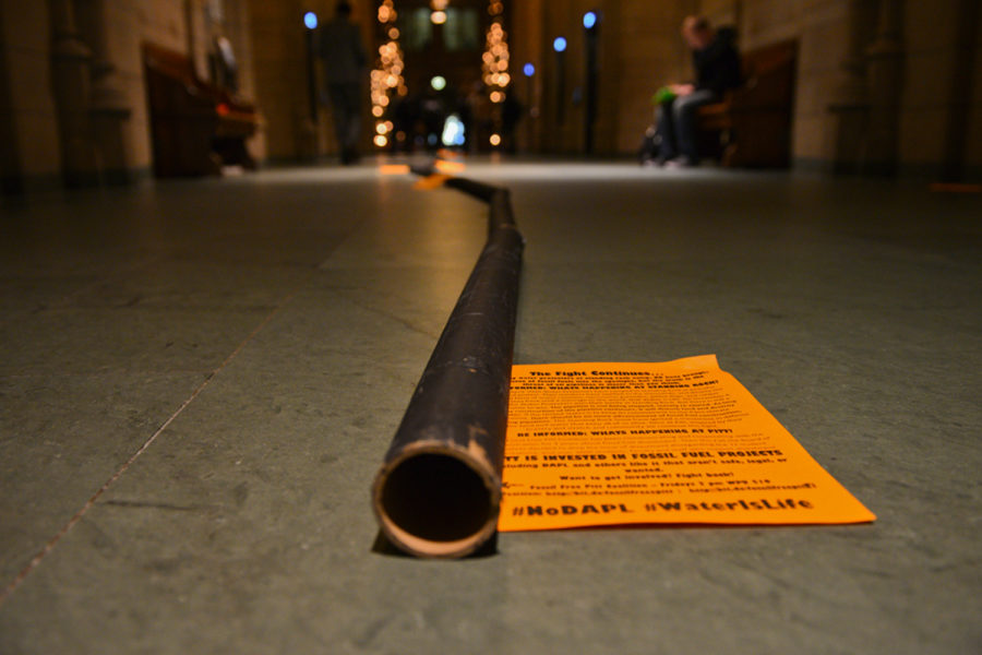 Members of the Fossil Free Pitt Coalition set up a cardboard “pipeline” in the Cathedral in December 2016 in protest of the pipeline on Standing Rock’s reservation.
