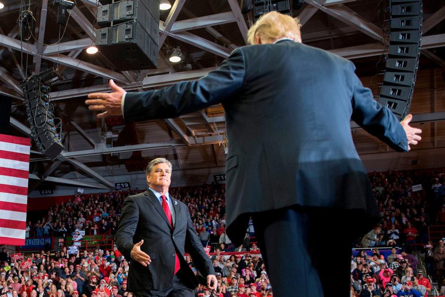 U.S. President Donald Trump greets Fox News talk show host Sean Hannity at a “Make America Great Again” rally in Cape Girardeau, Missouri, on Nov. 5, 2018. 
