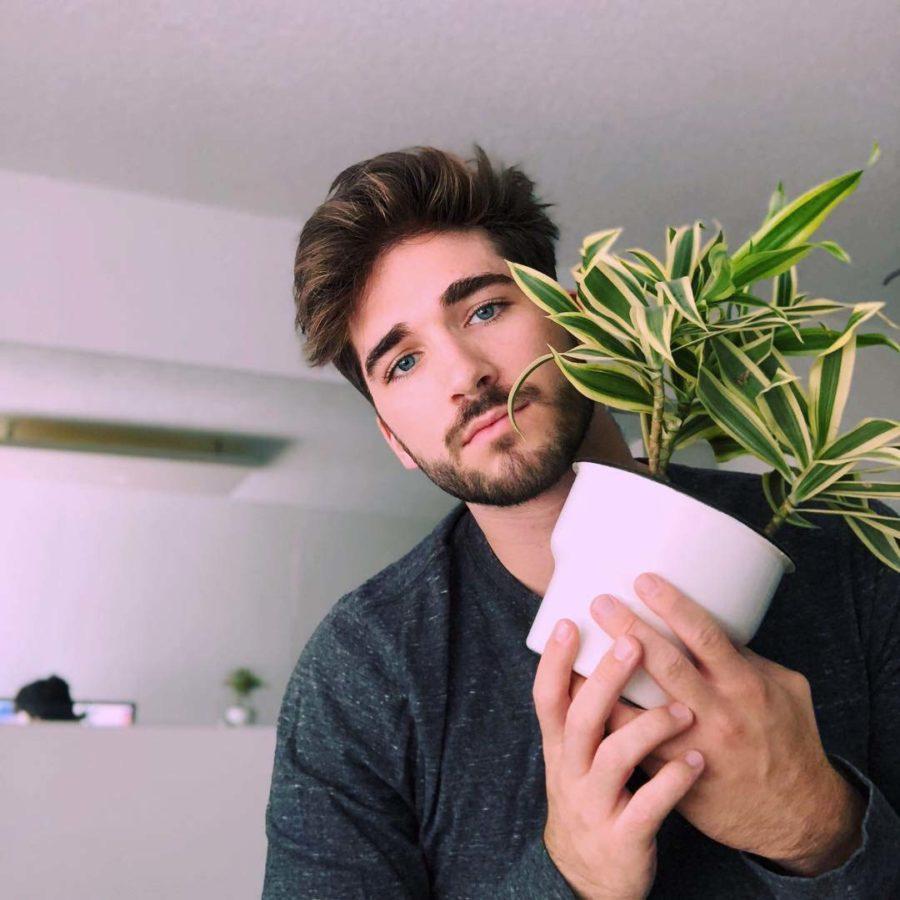 Cole Boillat poses with his plant, Jonathan. 
