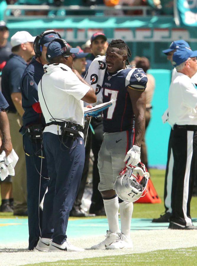 New England Patriots wide receiver Antonio Brown (17) talks with coaches during the second quarter against the Miami Dolphins on Sunday, Sept. 15, at Hard Rock Stadium in Miami Gardens, Florida. 