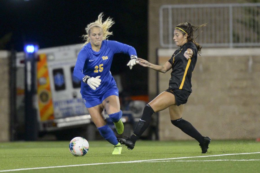 VCU’s sophomore midfielder Samantha Herabek (12) is prevented from shooting on Pitt’s goal by freshman goalkeeper Caitlyn Lazzarini (25).
