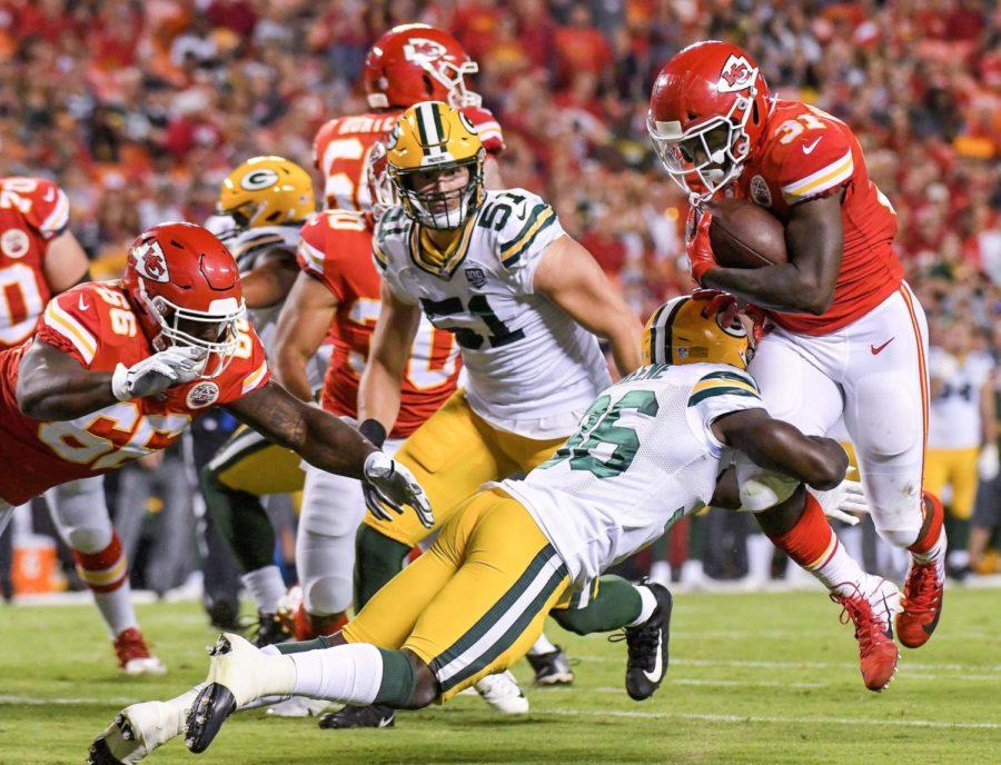 Kansas City Chiefs running back Darrel Williams (31) is stopped by Green Bay Packers defensive back Raven Greene (36) in the second quarter during a preseason game on Thursday, Aug. 30, 2018, at Arrowhead Stadiumin Kansas City, Missouri. 