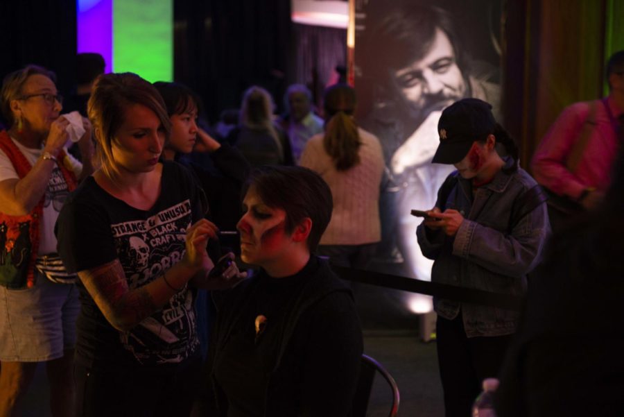 Visitors at Living with the Dead: A Party Celebrating the George A. Romero Archival receive makeup courtesy of ScareHouse. 