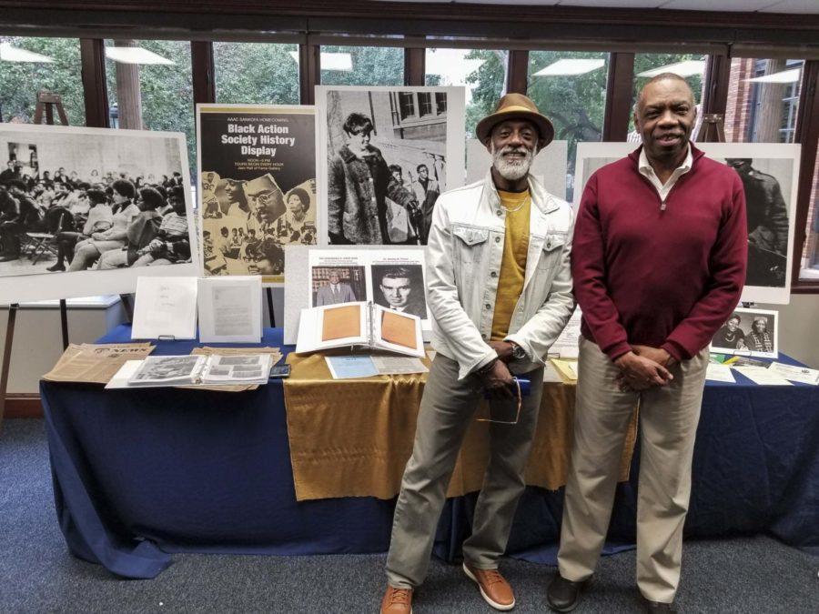 Alumni Ronald Morris, class of 1978 administration of justice major (left), and Henry Davis, class of 1976 history and economics major, pose in front of the Black Action Society History Display in the William Pitt Union on Friday afternoon. 