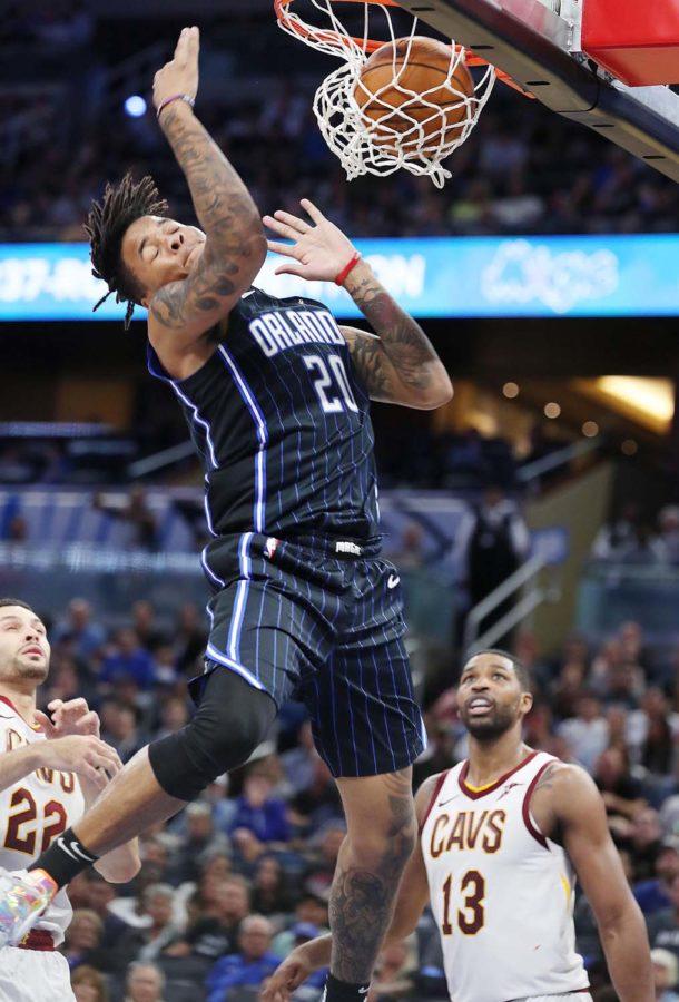 The Orlando Magics Markelle Fultz (20) soars above Cleveland Cavaliers defenders for a thunderous slam dunk at the Amway Center in Orlando, Florida, on Wednesday, Oct. 23. The Magic won, 94-85. 
