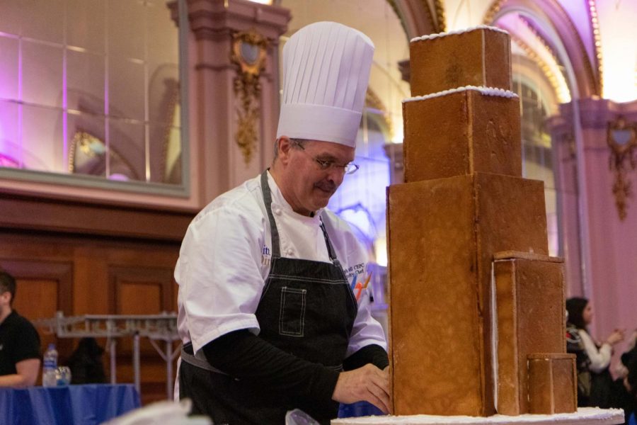 Chef Randolph Russell from Sodexo constructs a model Cathedral of Learning out of gingerbread. 