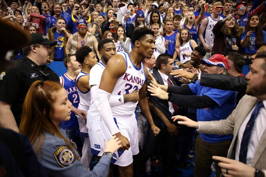 Kansas David McCormack (33) is held back by teammate Isaiah Moss during a brawl following a game against rival Kansas State at Allen Fieldhouse in Lawrence, Kansas, on Tuesday. Kansas won, 81-60. 