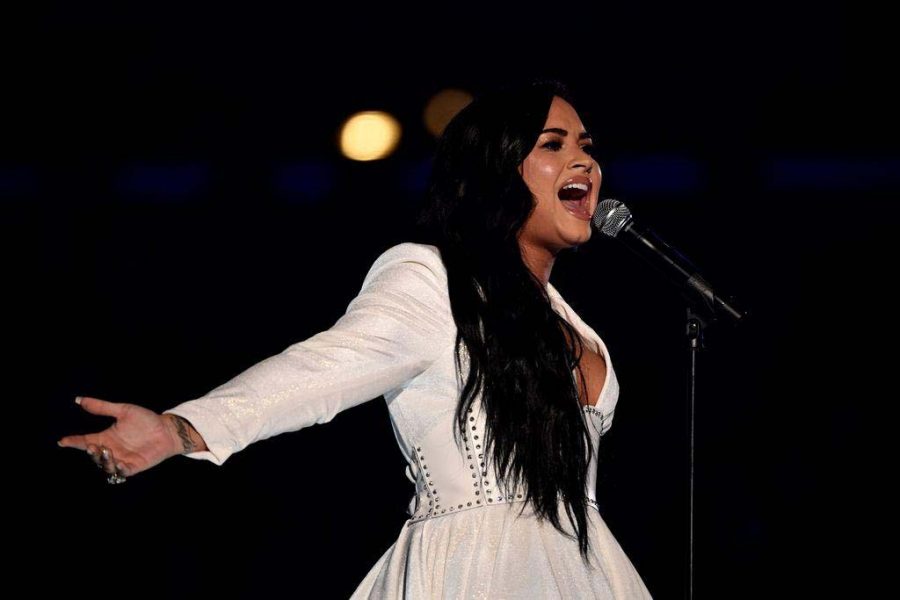 A visibly moved Demi Lovato belts Anyone at the Grammy Awards on Jan. 26 after choking up initially. Bets are being placed on whether Lovato’s rendition of the national anthem will be longer than two minutes. 