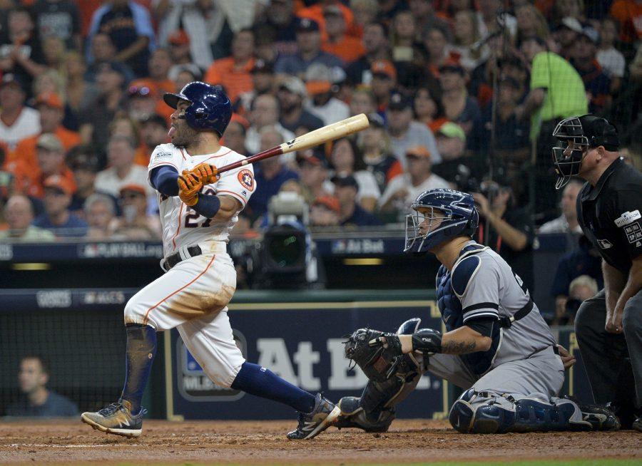 The Houston Astros Jose Altuve hits a solo home run in the fifth inning against the New York Yankees in Game 7 of the American League Championship Series at Minute Maid Park in Houston on Oct. 21, 2017. The Astros won, 4-0, to advance to the World Series.
