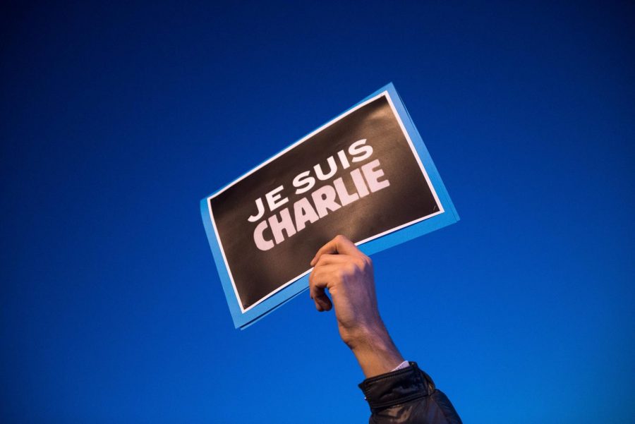 A man raises a Je Suis Charlie — translation: “I am Charlie” — sign during a rally in support of Charlie Hebdo on Jan. 7, 2015, in Marseille, France. 