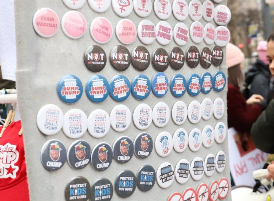 Magnets and buttons for sale are displayed at the 2019 Pittsburgh Womens’ March. 