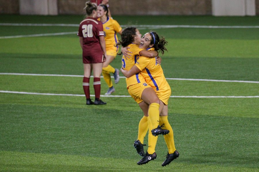 Junior forward Anna Rico (77) celebrates with teammate Chloe Minas (15) after putting up Pitts fourth goal on Boston College during Thursdays 4-3 victory over the Eagles. 