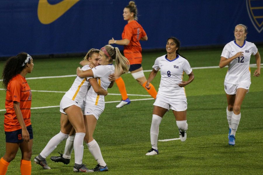 Sophomore forward Amanda West (9) celebrates with her teammates after scoring a goal on Syracuse during Pitt’s 2-0 victory over the Orange on Sept. 17. 