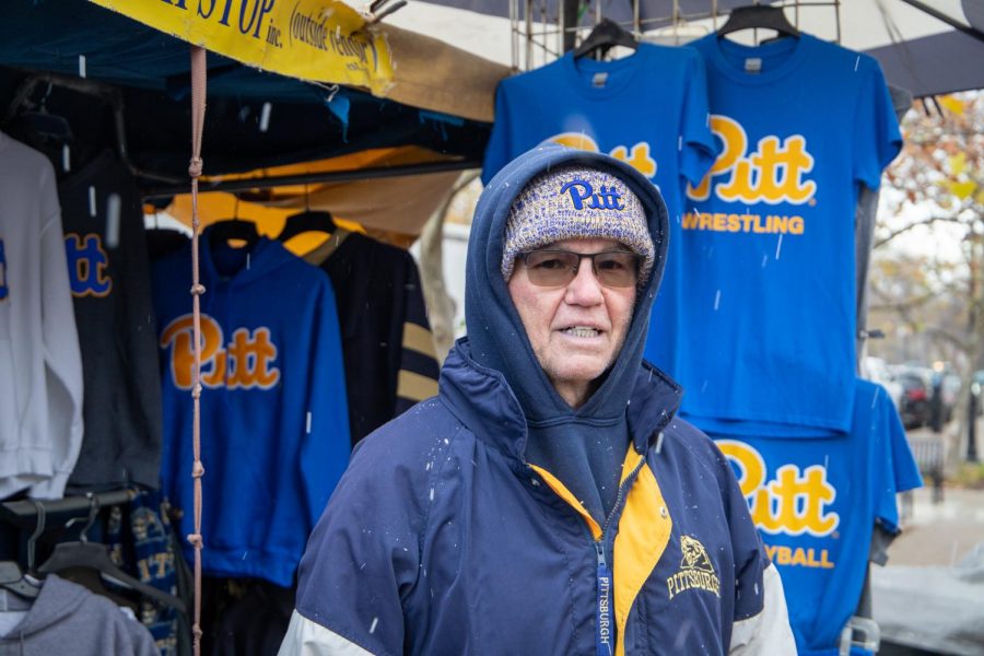 Chas Bonasorte, owner of The Pittsburgh Stop on the corner of Forbes Avenue and Bigelow Boulevard, stands in front of his apparel and merchandise stand. 