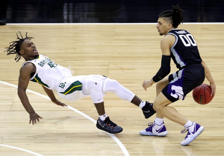 Mike McGuirl (00) of the Kansas State Wildcats controls the ball as Davion Mitchell (45) of the Baylor Bears defends during the quarterfinal game of the Big 12 basketball tournament at the T-Mobile Center on March 11 in Kansas City, Missouri.