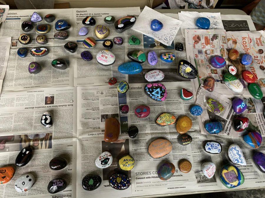 Hand-painted stones in the courtyard of East End Cooperative Ministries at the second annual “Service Setting Stones of Love and Hope” in Squirrel Hill on Sunday. ​​