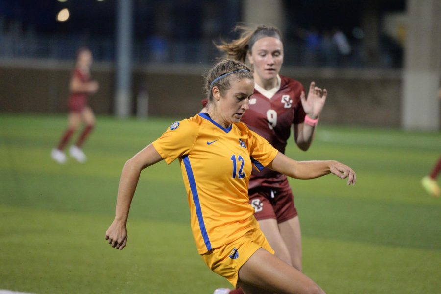 Pitt’s Anna Bout (12) fights for possession of the ball against Boston College’s Sam Smith (9) at Ambrose Urbanic Field on Thursday night. 