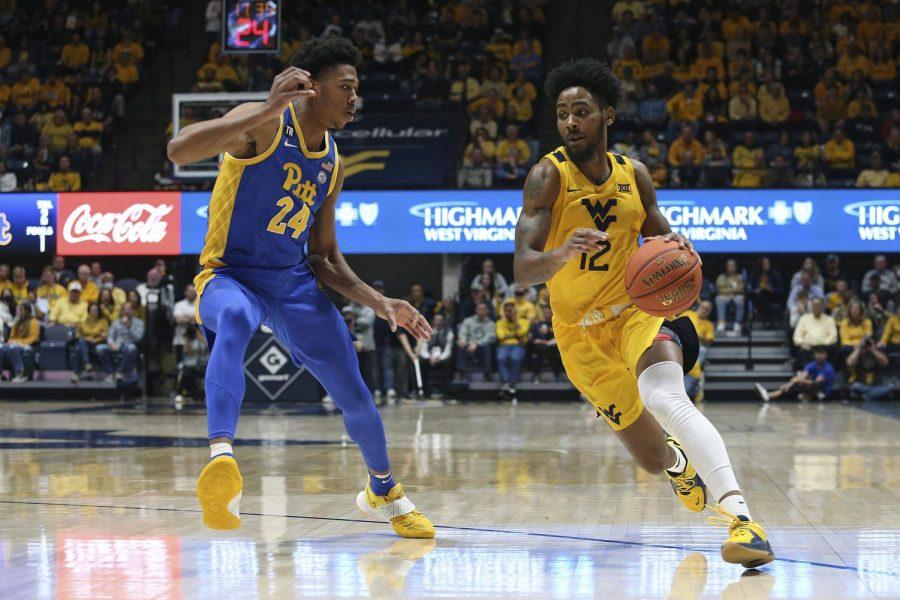West Virginia guard Taz Sherman (12) drives against Pittsburgh guard William Jeffress (24) during the second half of an NCAA college basketball game in Morgantown, W.Va., Friday, Nov. 12, 2021. 
