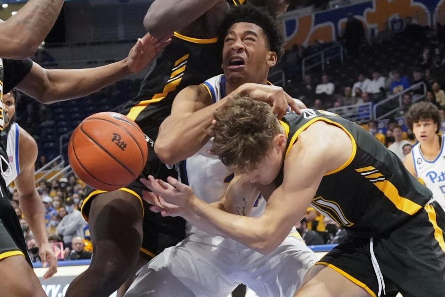 Pittsburghs William Jeffress, in white, and Towsons Jason Gibson (11) battle for a loose ball during the first half of an NCAA college basketball game Friday, Nov. 19, 2021, in Pittsburgh. 