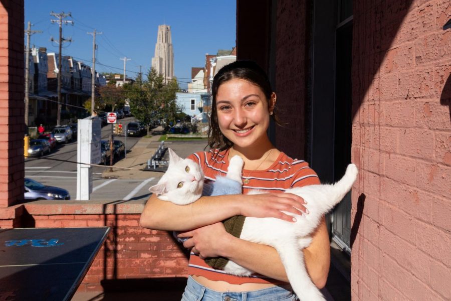 Delphie Backs, a junior applied developmental psychology major, adopted her cat Olaf, a 2-year-old white short-hair, from the Beaver Humane Society last year. 