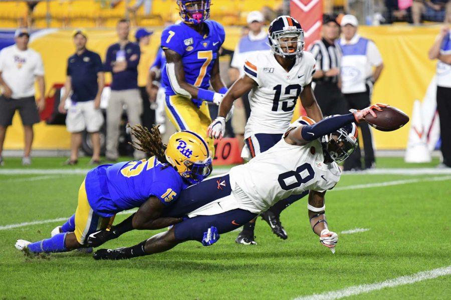Pitt cornerback Jason Pinnock (15) tries to stop Virginia wide receiver Hasise Dubois (8) reaching for the end zone for a touchdown during Pitt’s game against the Virginia Cavaliers in September 2019. 
