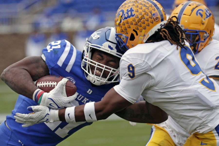 Duke running back Mataeo Durant (21) and Pitt defensive back Brandon Hill (9) collide as Durant holds the ball during Saturday’s game at Duke’s Wallace Wade Stadium in Durham, N.C.