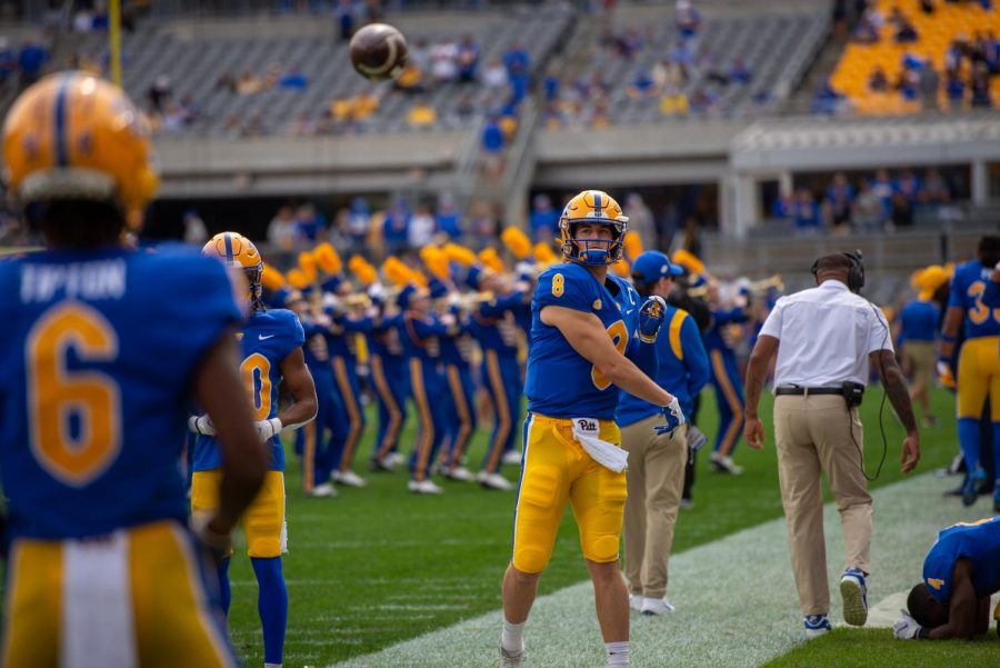 Kenny Pickett practices throwing the ball on the sidelines of the Pitt vs. UNH game in September.
