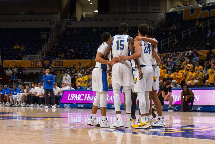 Pitt men’s basketball players huddle at the exhibition game versus Gannon University Monday night, as head coach Jeff Capel looks on. 