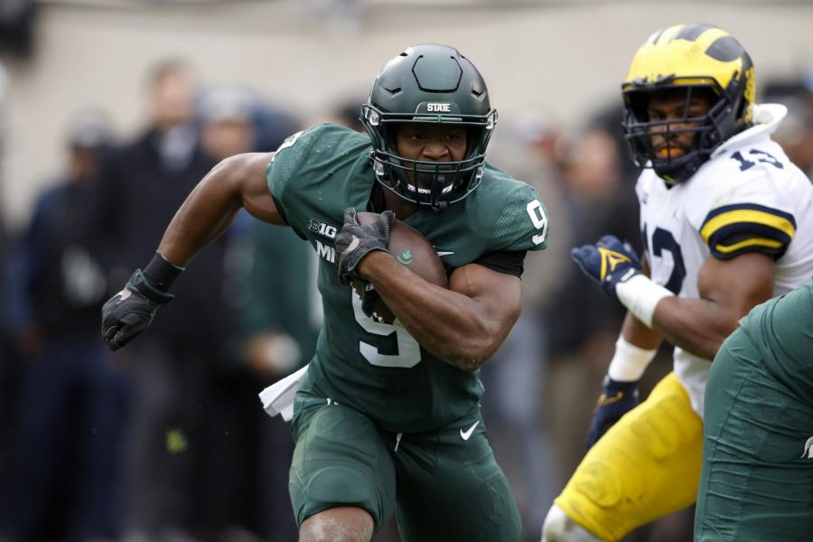 Michigan State's Kenneth Walker III (9) runs with the ball during the first quarter of a game against University of Michigan at Michigan State’s Spartan Stadium in East Lansing, Mich. on Saturday.