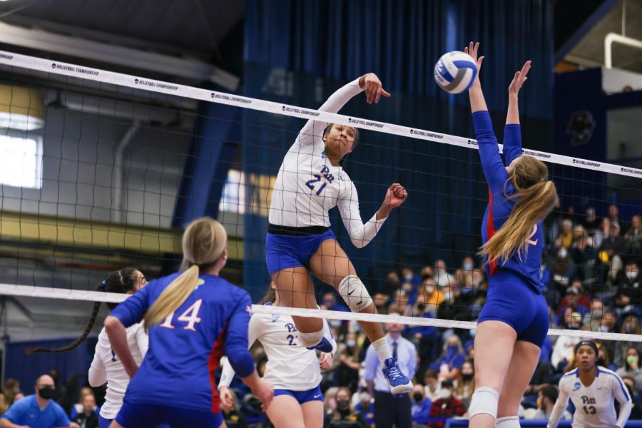 Senior middle blocker Serena Gray (21) spikes the ball against Kansas during Thursday afternoon's Sweet 16 match at Fitzgerald Field House.  