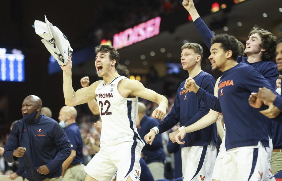 Virginia players celebrate the winning basket during an NCAA college basketball game against Pittsburgh in Charlottesville, Va., Friday, Dec. 3, 2021. Virginia defeated Pittsburgh 57-56. 